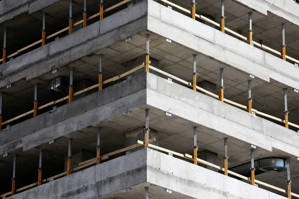 A reinforced concrete frame with props still supporting the slab above
